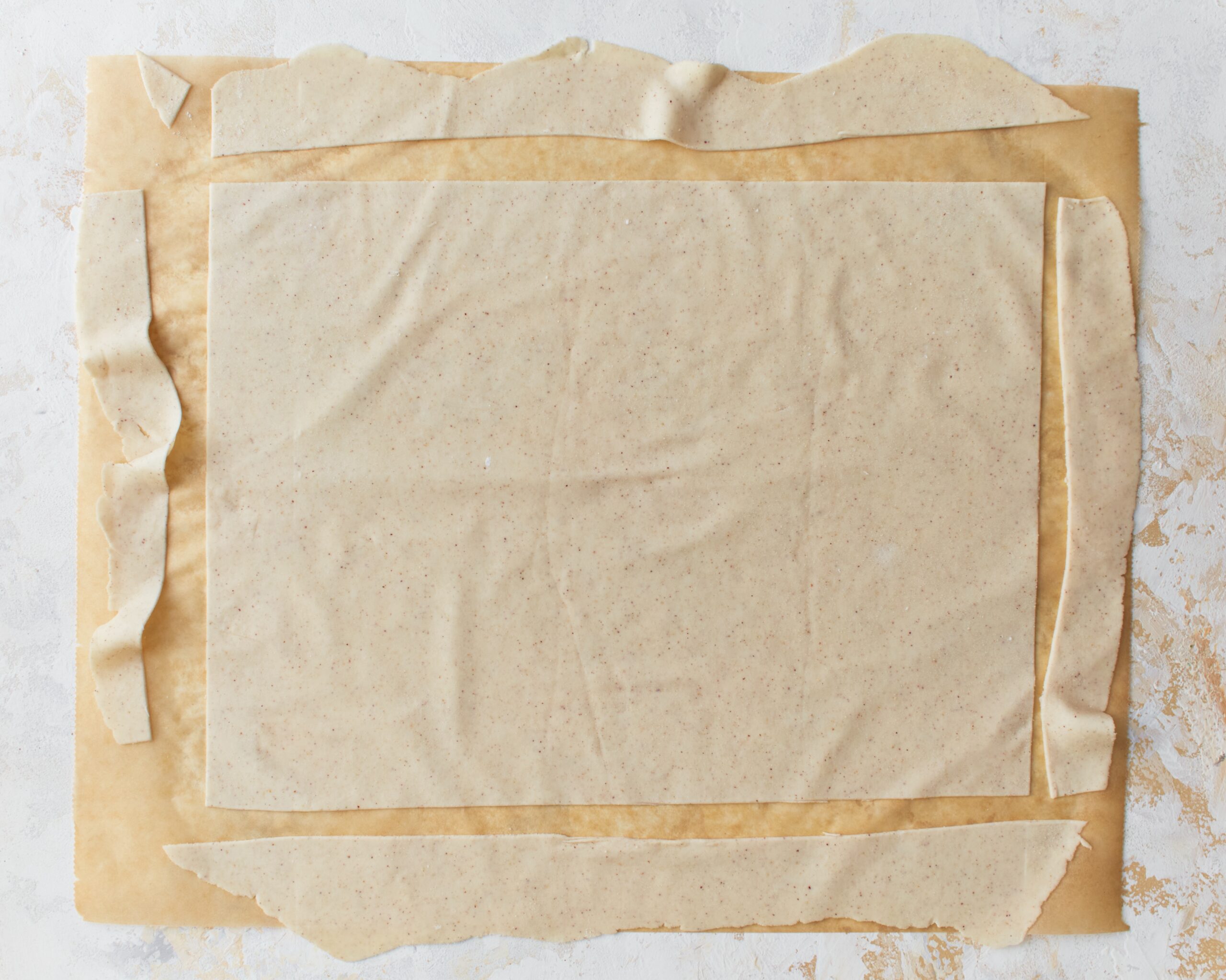 Rolled out gluten-free phyllo dough cut into a rectangle.