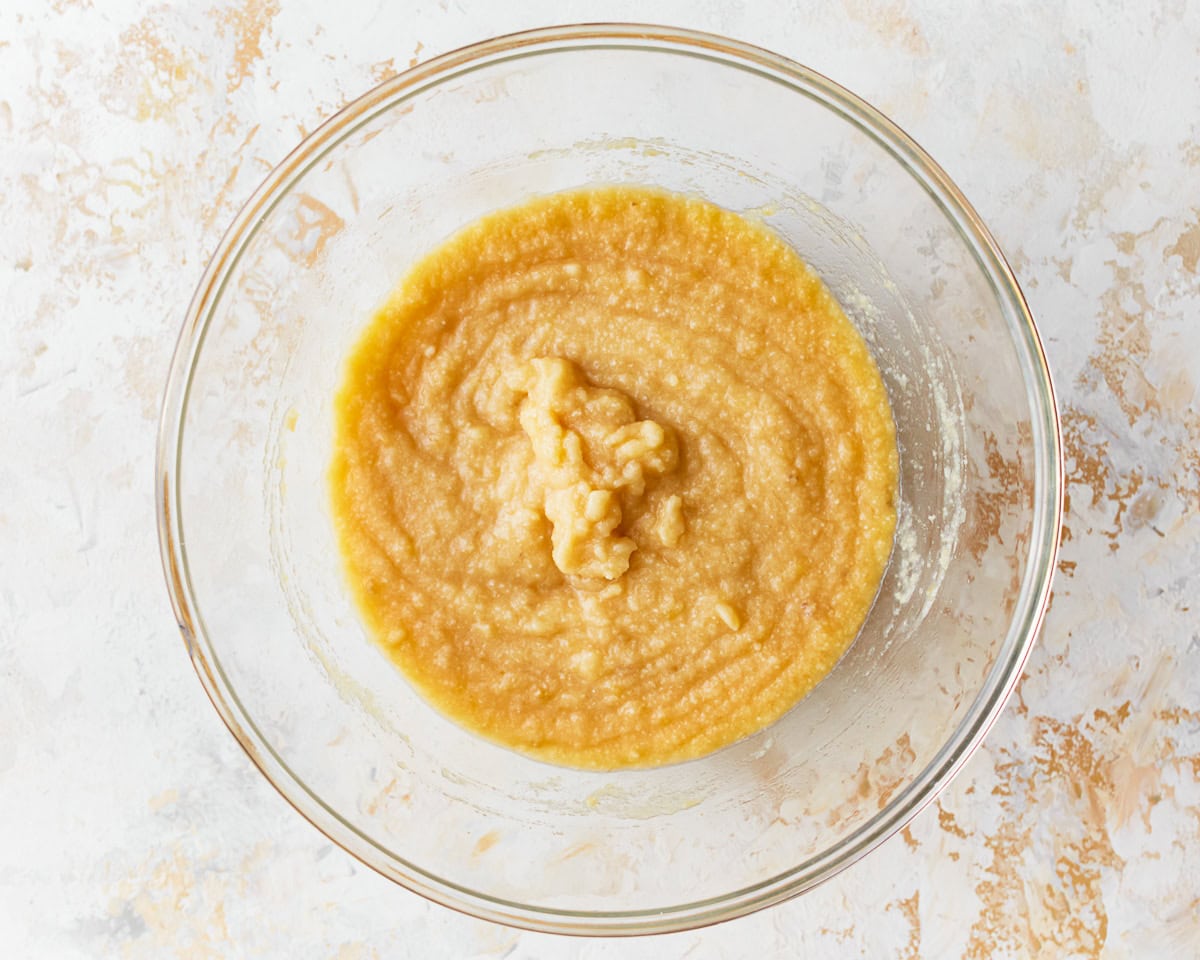 Batter for coconut flour muffins in a glass mixing bowl.