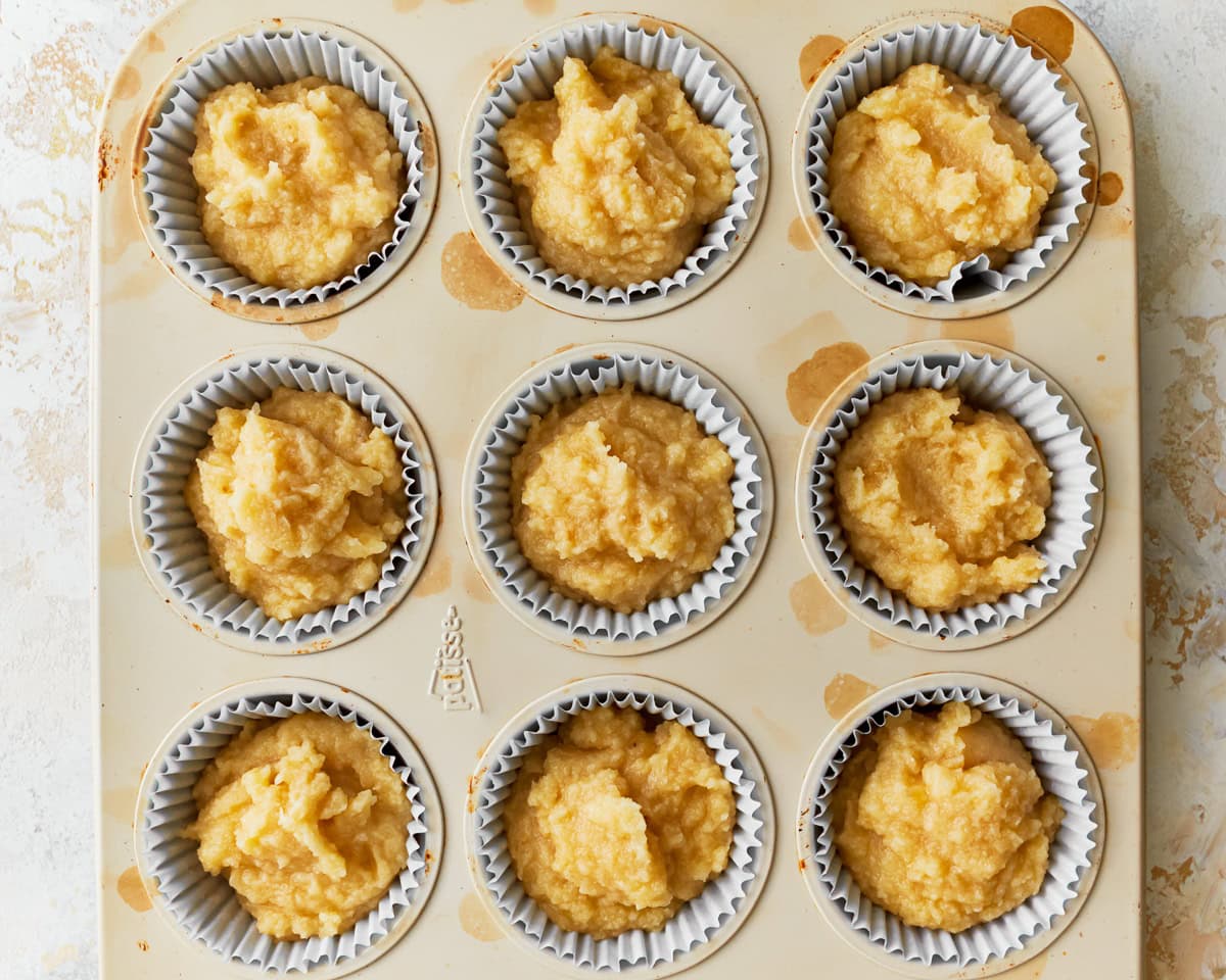 Batter added to a lined muffin pan for coconut flour muffins.