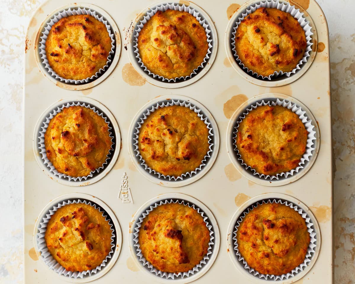 Freshly baked coconut flour muffins in a muffin pan.