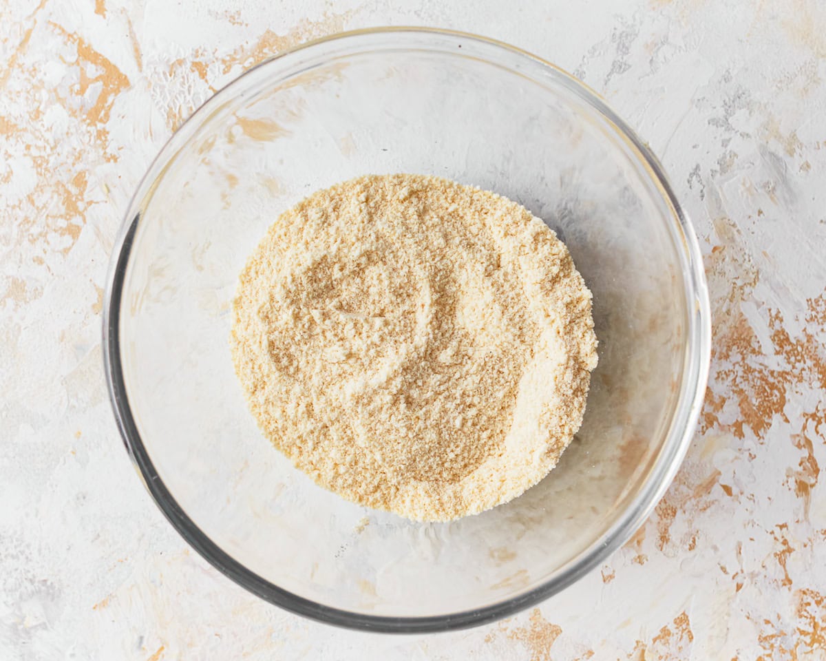 Dry ingredients for coconut flour muffins in a glass mixing bowl.