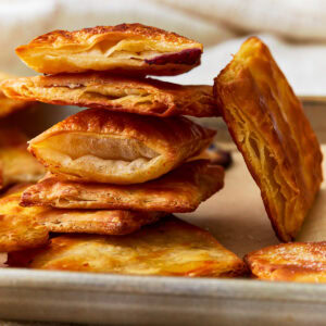 Side view of gluten-free puff pastry squares stacked on top of each other.