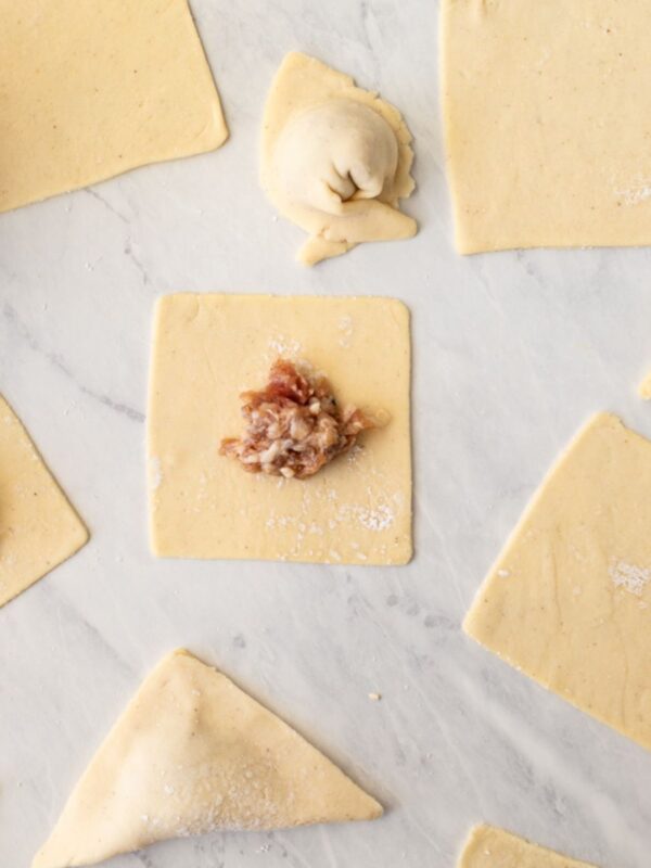 Overhead view of empty gluten-free wonton wrappers and gluten-free wontons