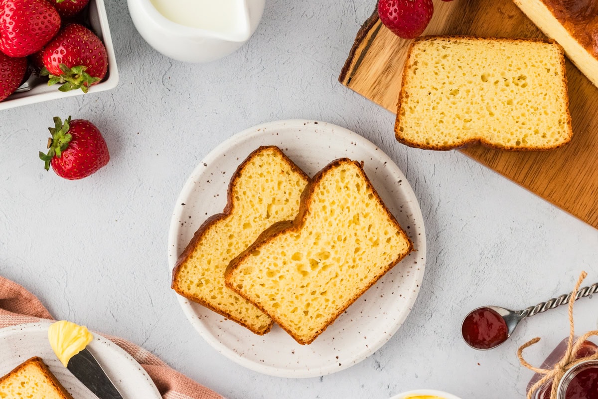 Overhead view of slices of gluten-free brioche bread on a plate.