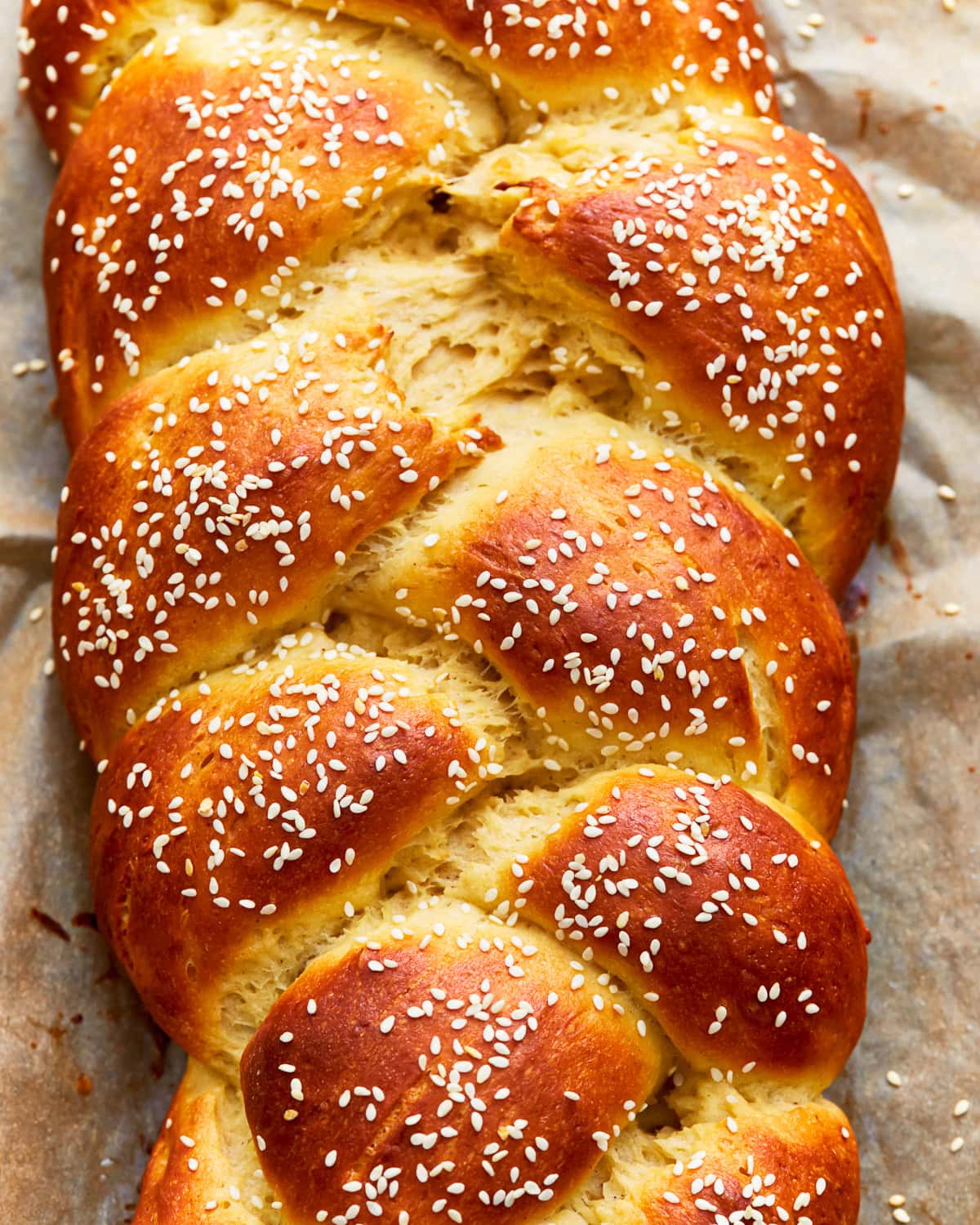 Overhead view of gluten-free challah bread topped with sesame seeds.