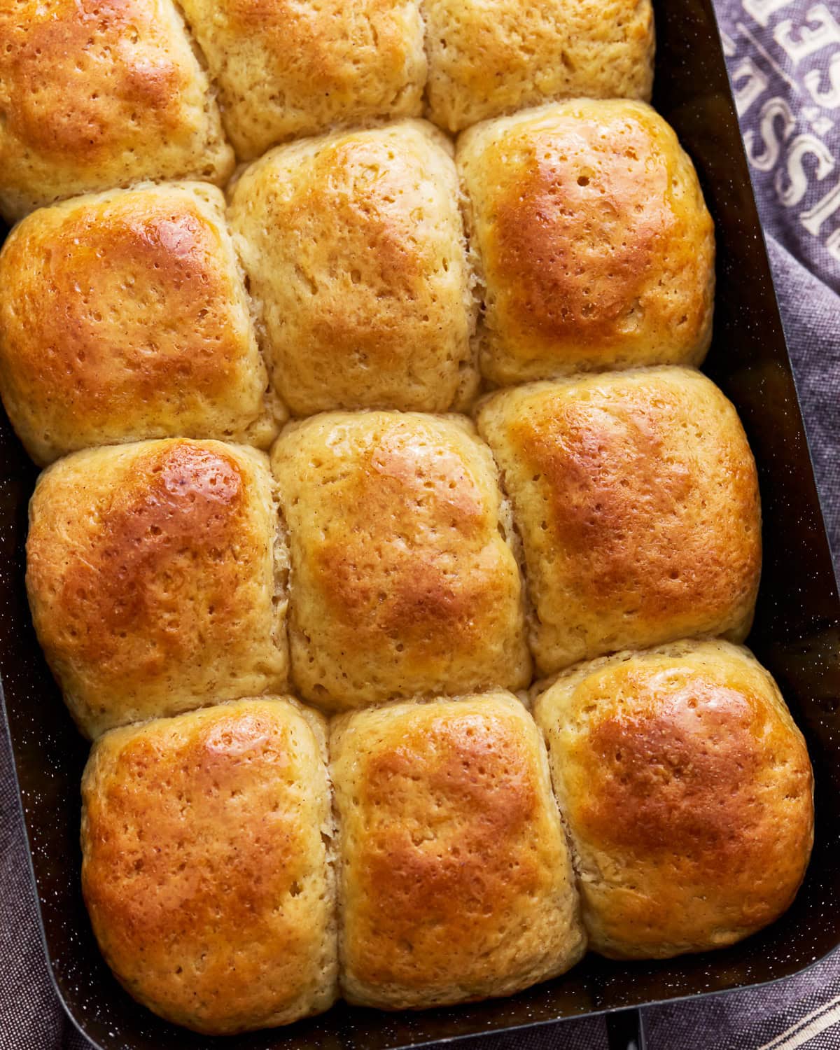 Overhead view of gluten-free hawaiian rolls in a baking pan.