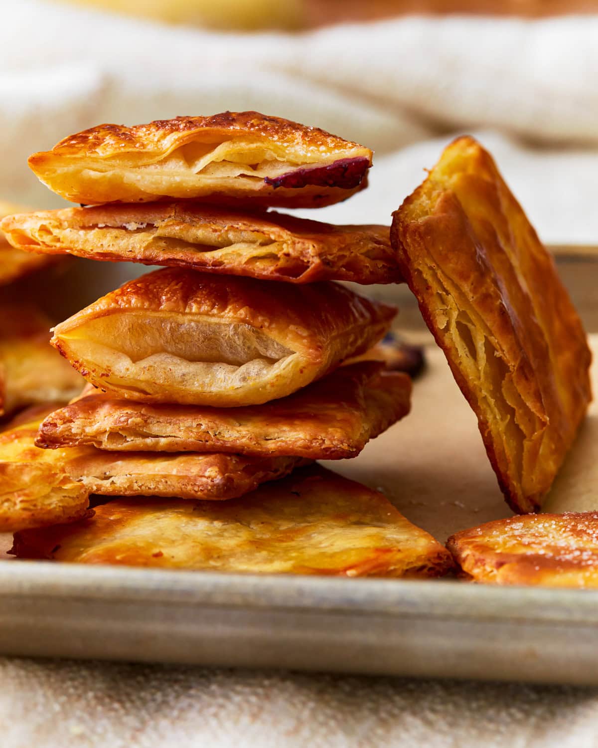 Gluten-free puff pastry squares stacked on top of each other.