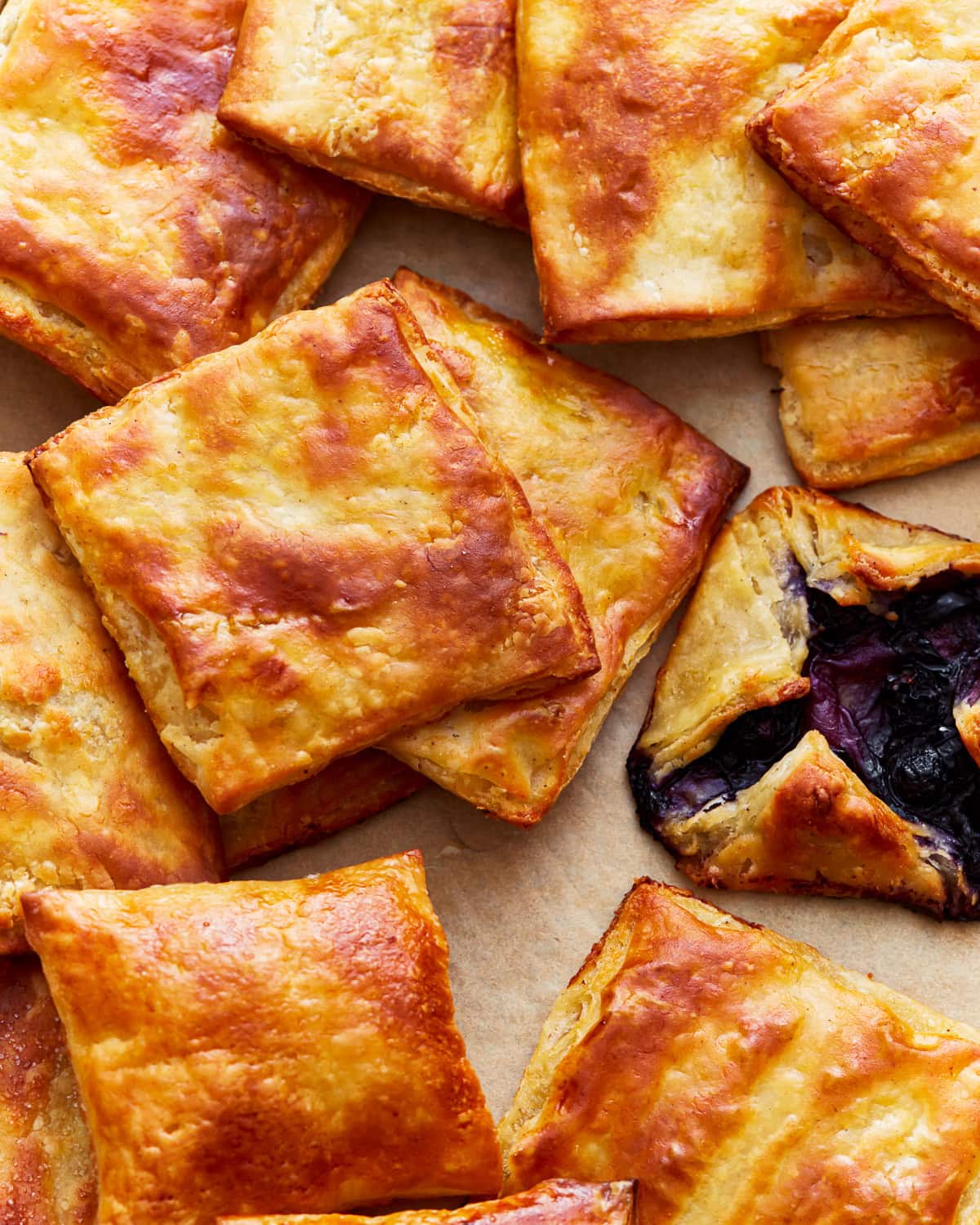 Overhead view of gluten-free puff pastry squares with a Danish pastry.