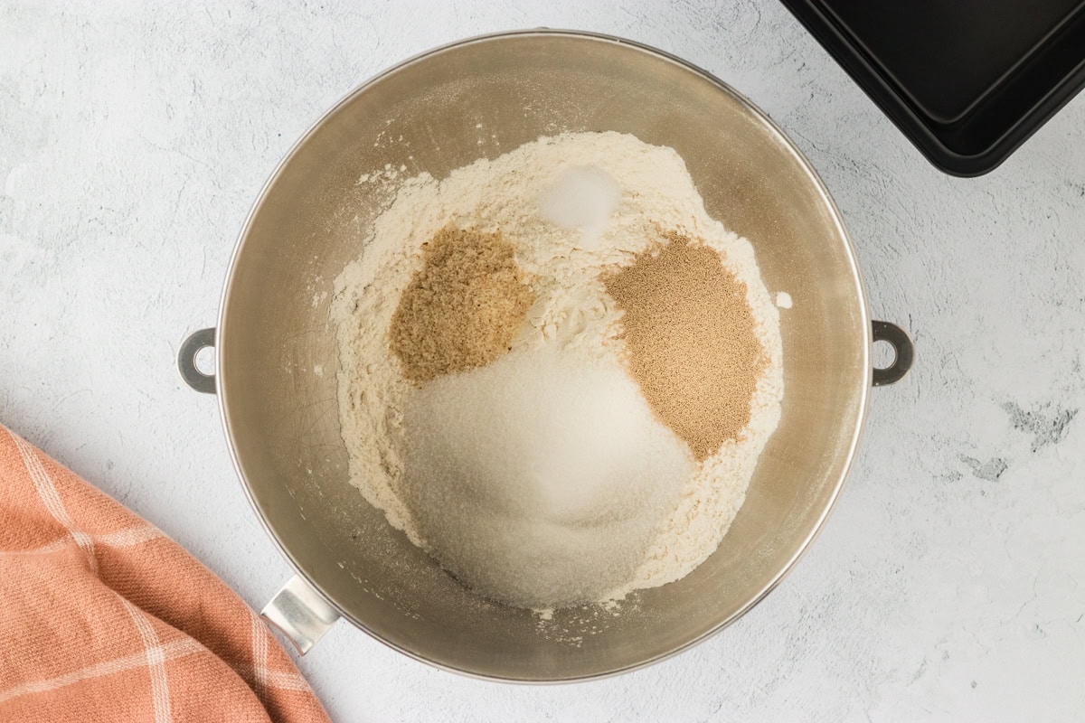 Gluten-free flour, sugar, psyllium husk, and instant yeast in a mixing bowl.