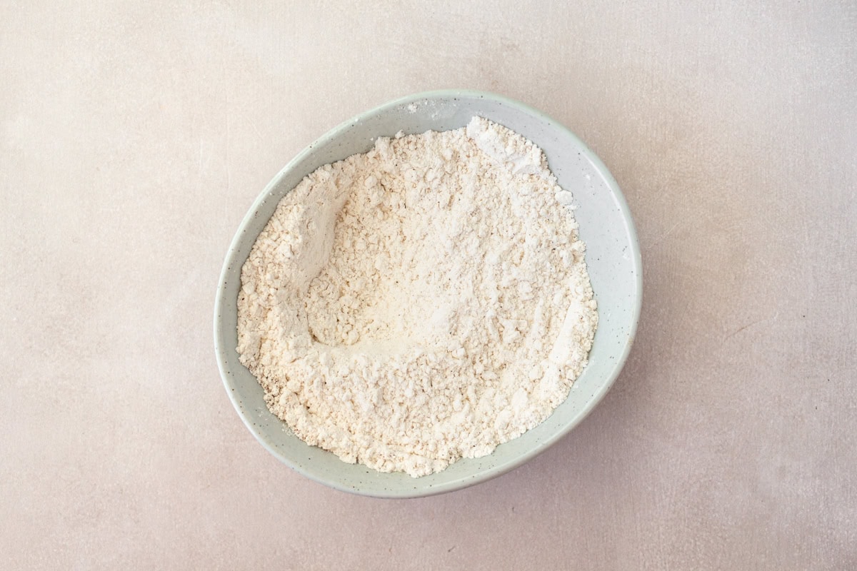 Dry ingredients for gluten-free fried onions in a bowl.