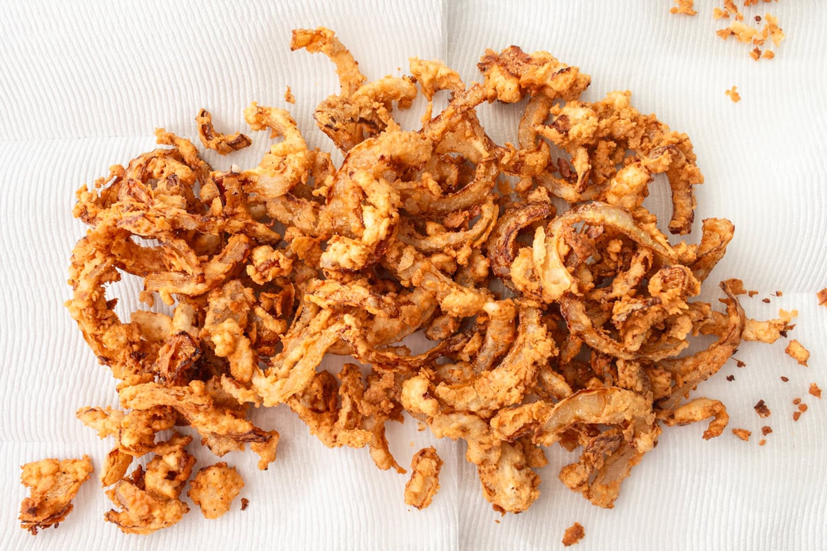 Gluten-free fried onions on a paper towel.