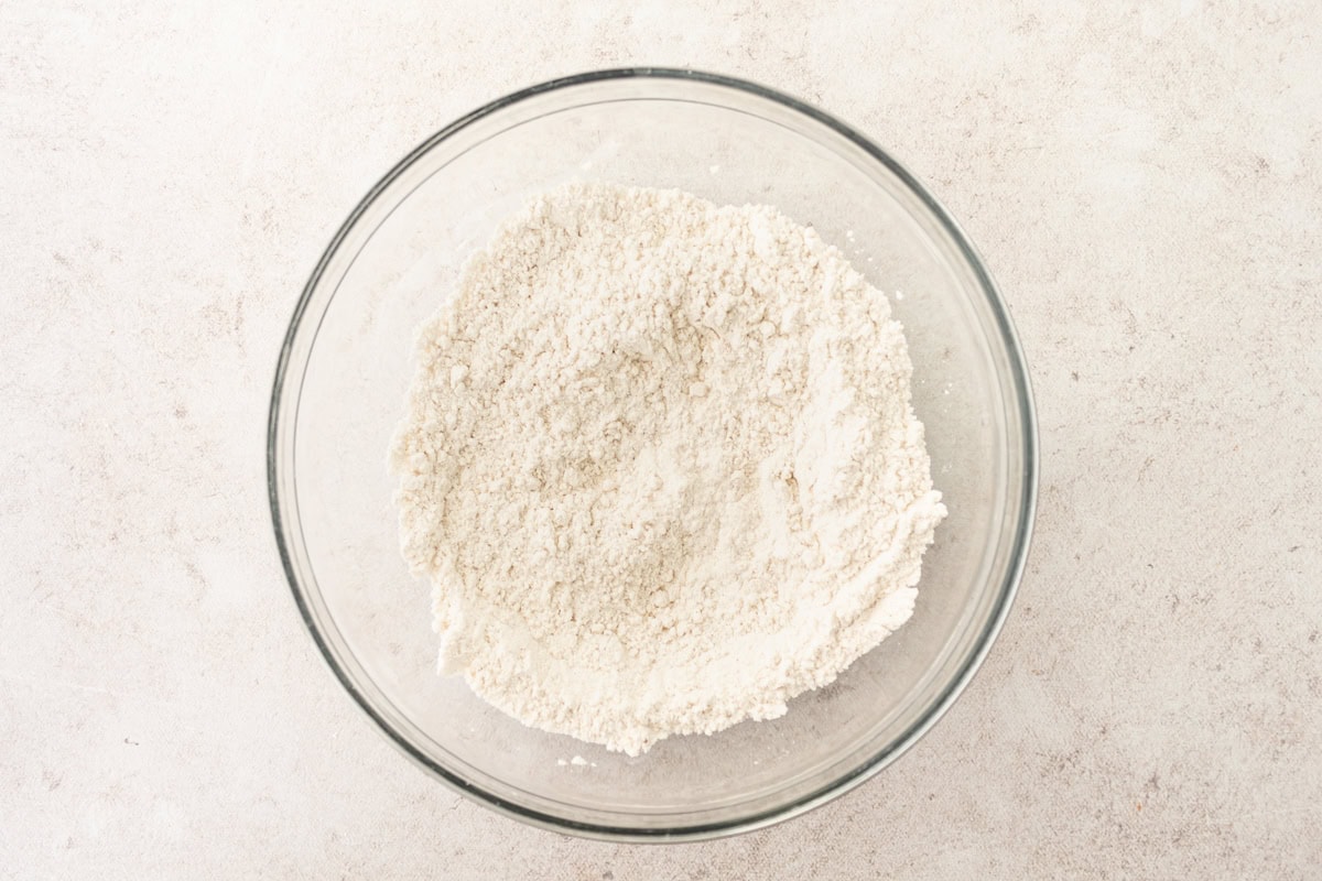 Dry ingredients for gluten-free popovers in a glass mixing bowl.