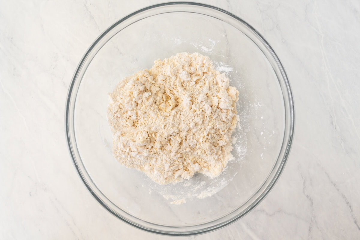 A shaggy gluten-free wonton wrapper dough in a glass mixing bowl.