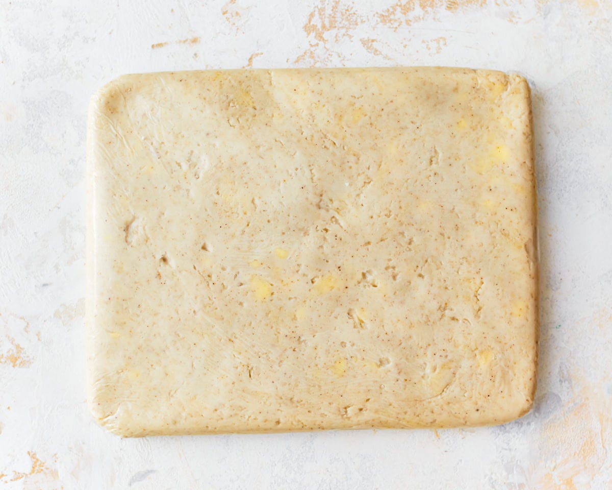 Gluten-free puff pastry dough shaped into a rectangle.