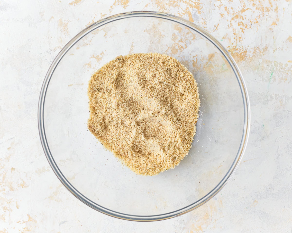 Dry ingredients for almond flour crackers in a glass mixing bowl.