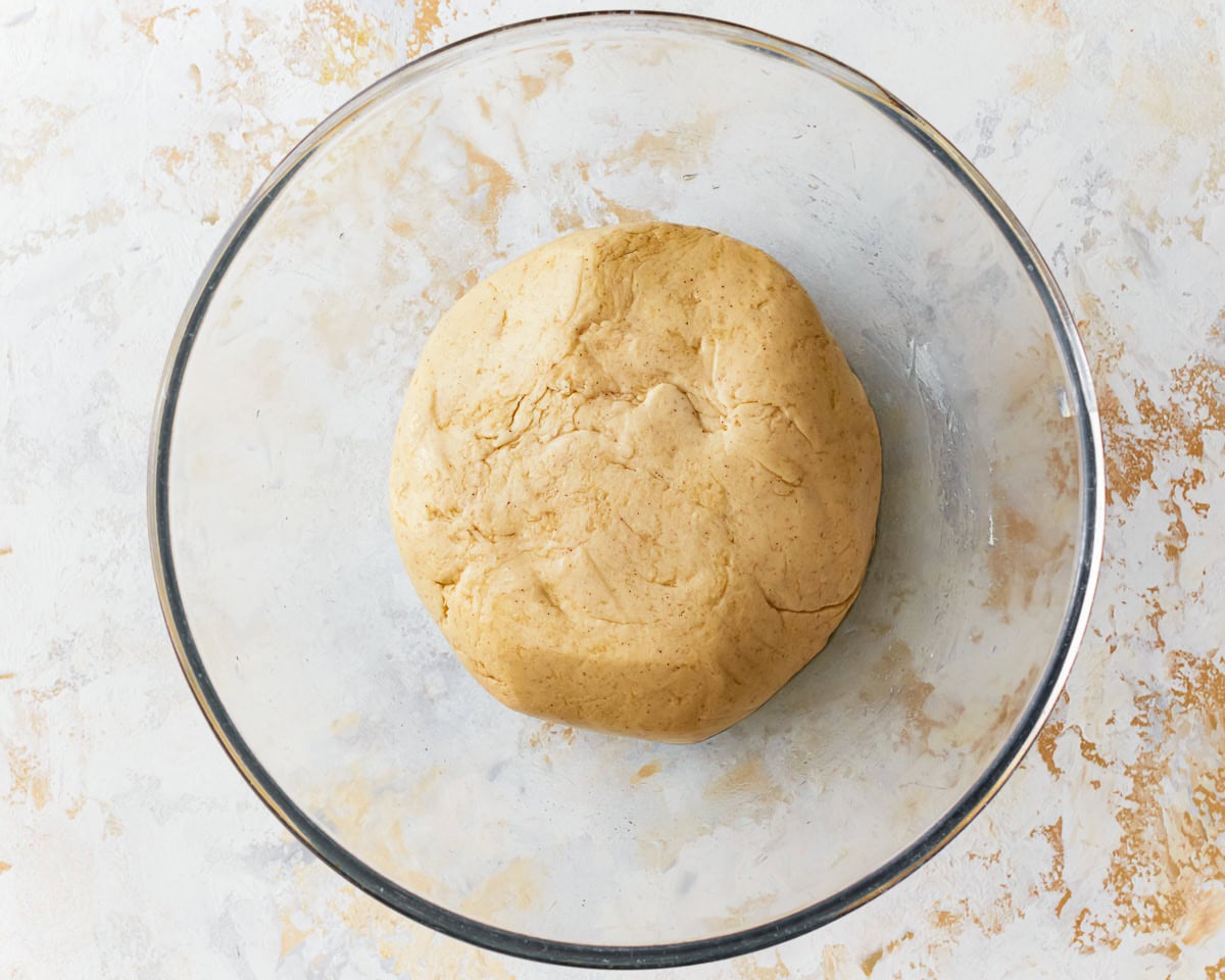 Gluten-free hawaiian roll dough in a glass mixing bowl.