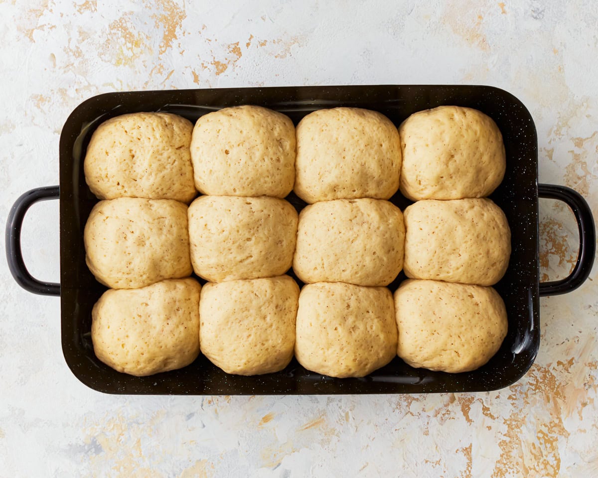 Gluten-free hawaiian roll dough in a baking pan after proofing.